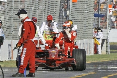 Ferrari Formula One driver Kimi Raikkonen of Finland sits on his car as he gets back to the pit area after failing to complete the Australian Grand Prix in Melbourne, Australia, Sunday March 16, 2008 (Source: AP)